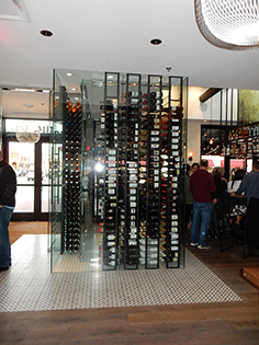 Custom glass wine rack display at Vasilis restaurant
